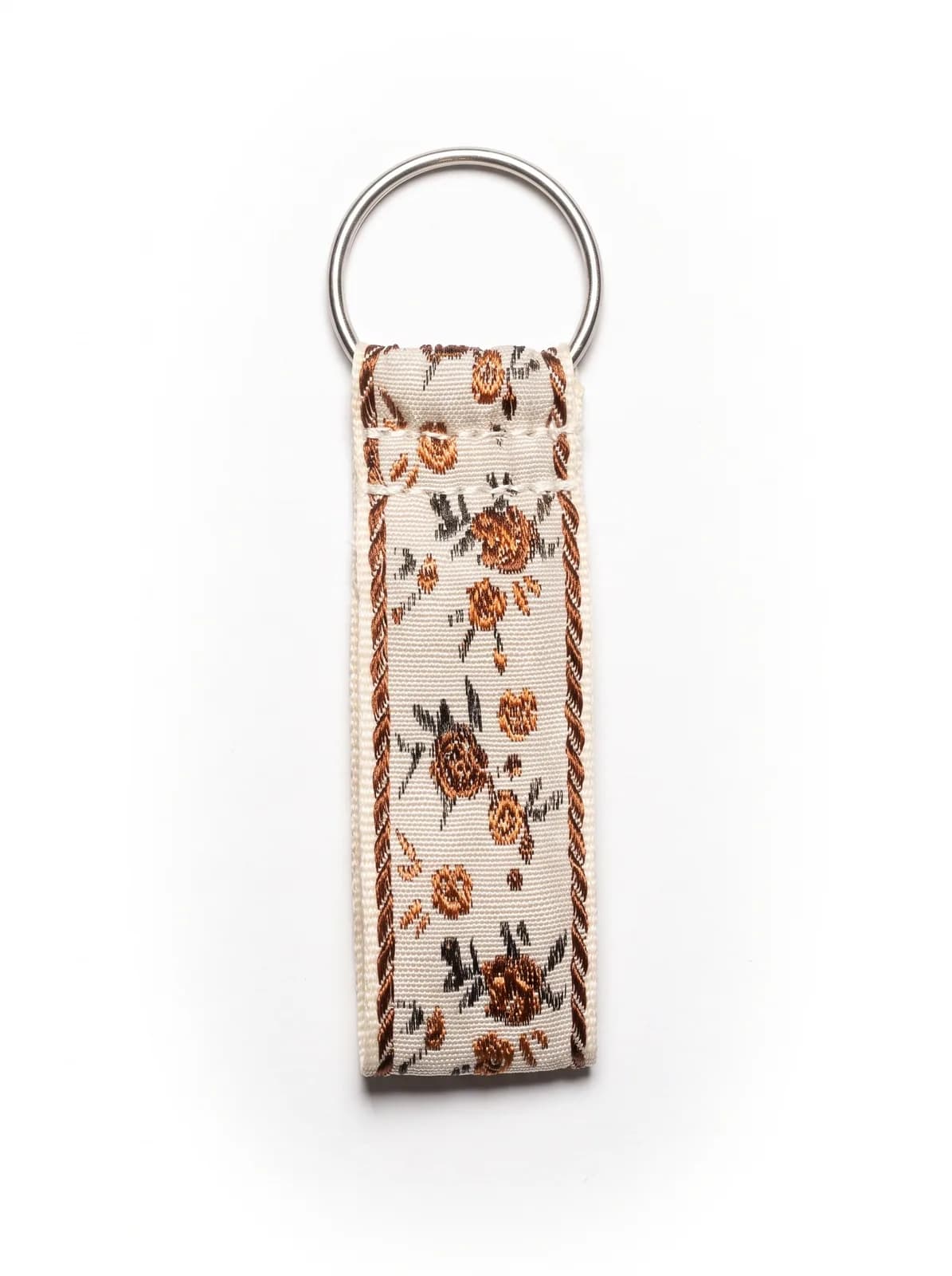 Ivory brocade key fob on a white background