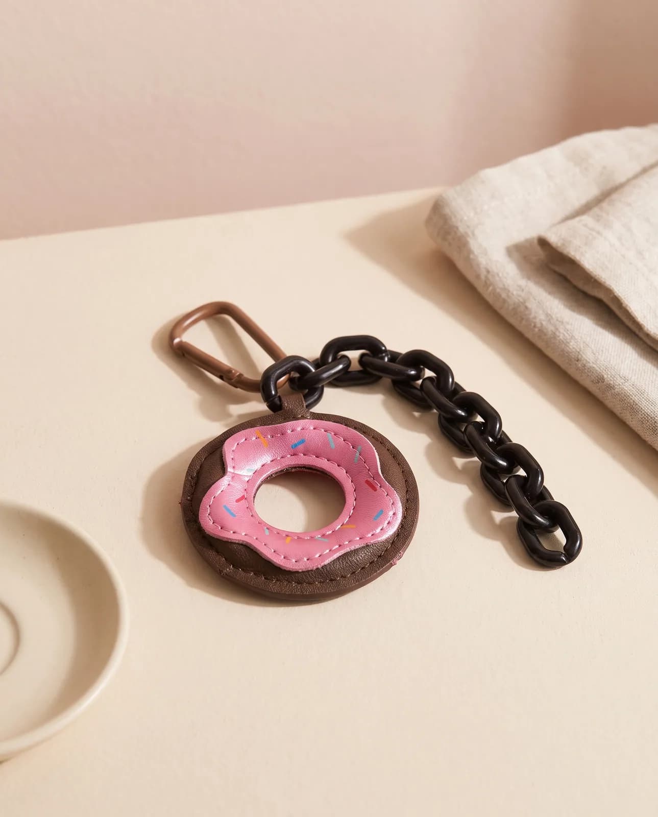 Doughnut leather charm on cream plaster in window light