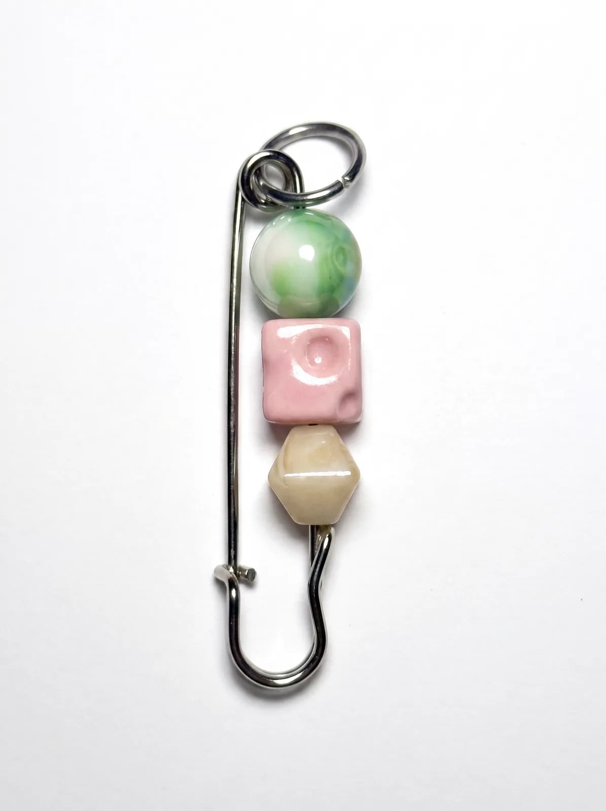 Pastel ceramic bead pin on a white background