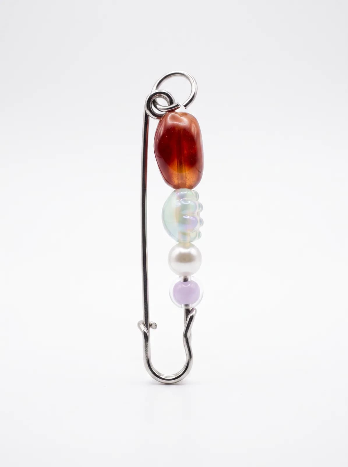 Ruby and pearl bead pin on a white background
