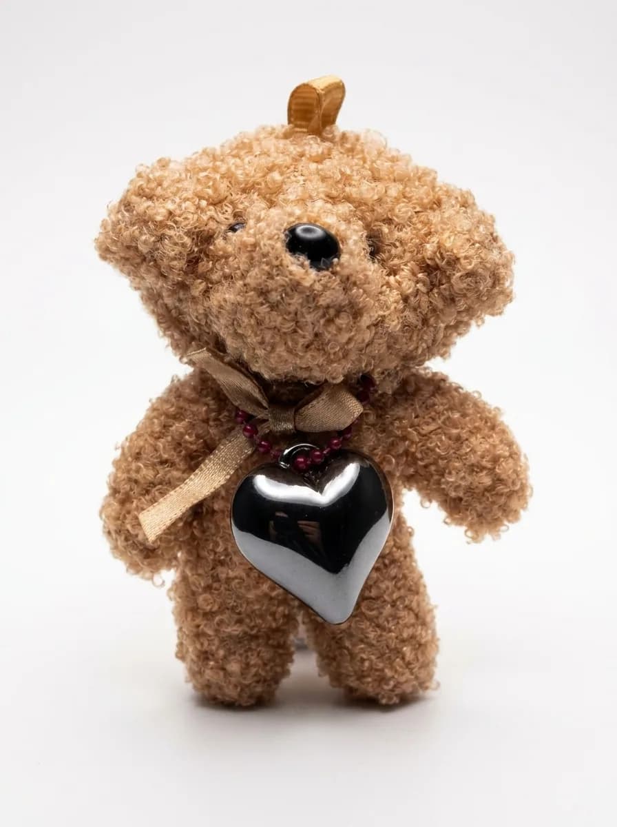 Teddy heart charm on a white background
