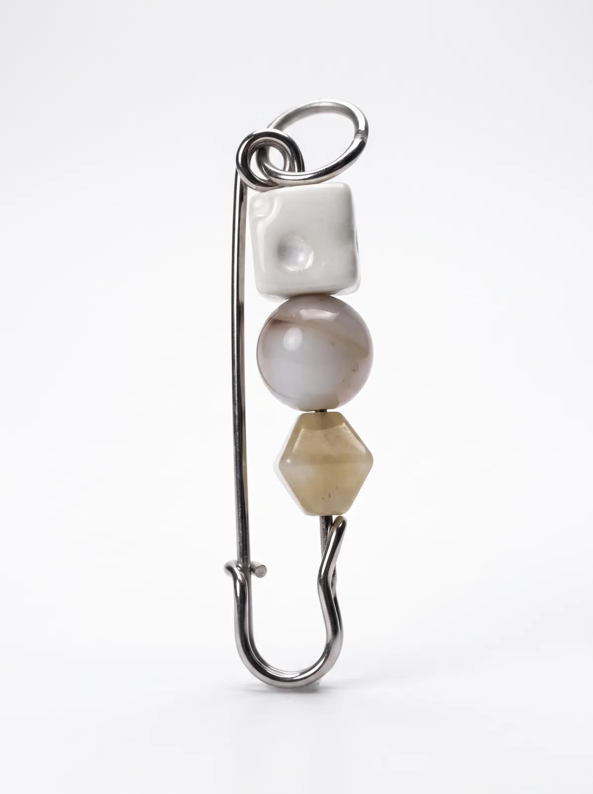 Neutral ceramic bead pin on a white background
